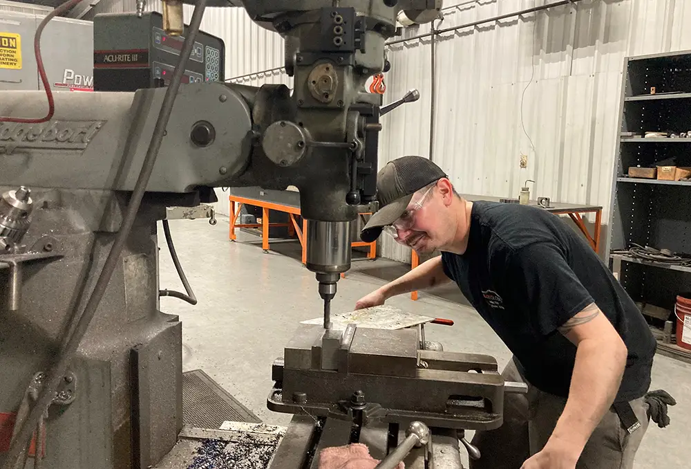 Tool and die apprentice Ty Cobb works at the TELOS Global plant in Caryville, Tennessee, which manufactures parts for electric vehicles. The University of Tennessee, Knoxville, is partnering with TELOS and other employers in advanced manufacturing and green construction industries on East Tennessee Works, a green jobs initiative.