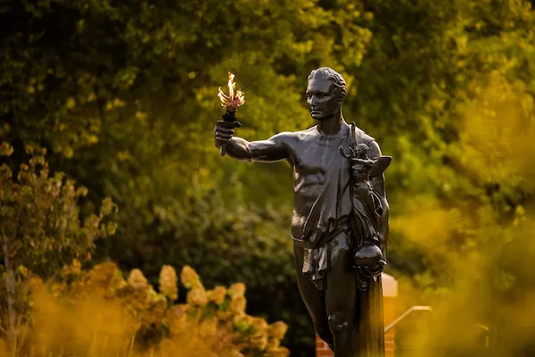 The University of Tennessee's Torchbearer statue holds a flame early in the morning.